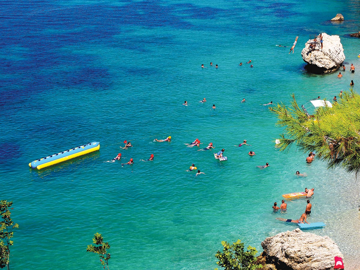 People swimming on a beach in Vlora