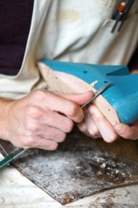 A men working in a shoe manufacturing fabric